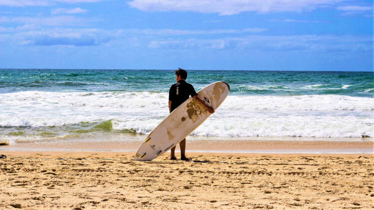man holding surfingboard